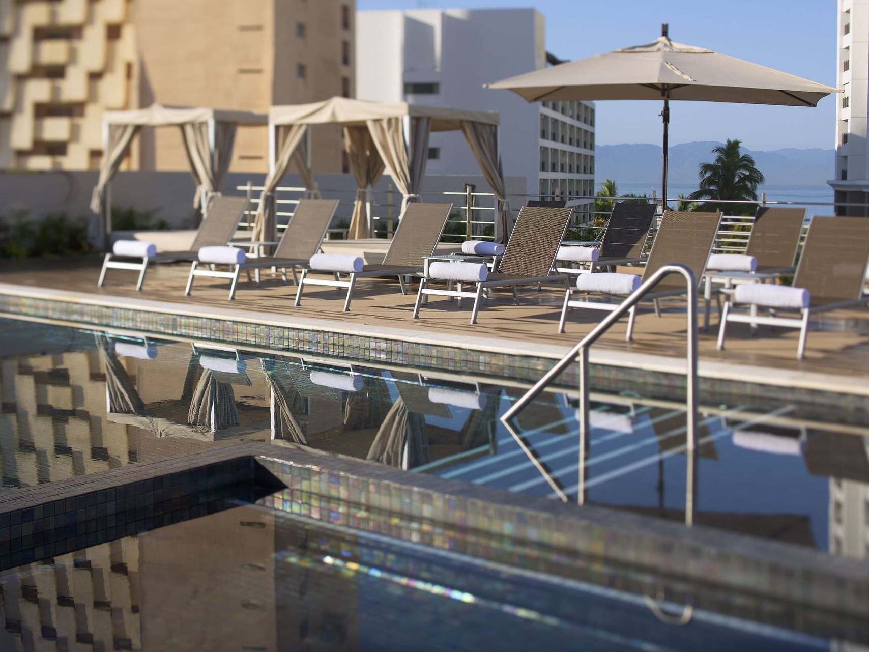Outdoor swimming pool with loungers at Fiesta Inn Hotels