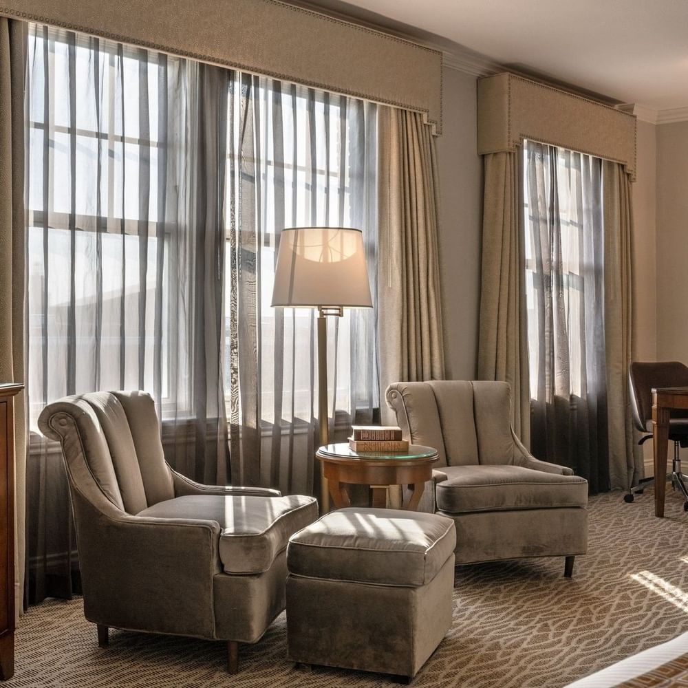 Elegant Deluxe King room with seating area and large windows at Warwick Melrose - Dallas.