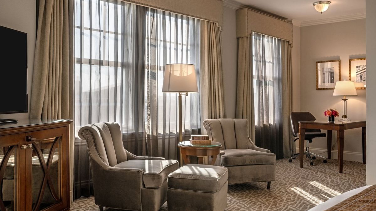 Elegant Deluxe King room with seating area and large windows at Warwick Melrose - Dallas.