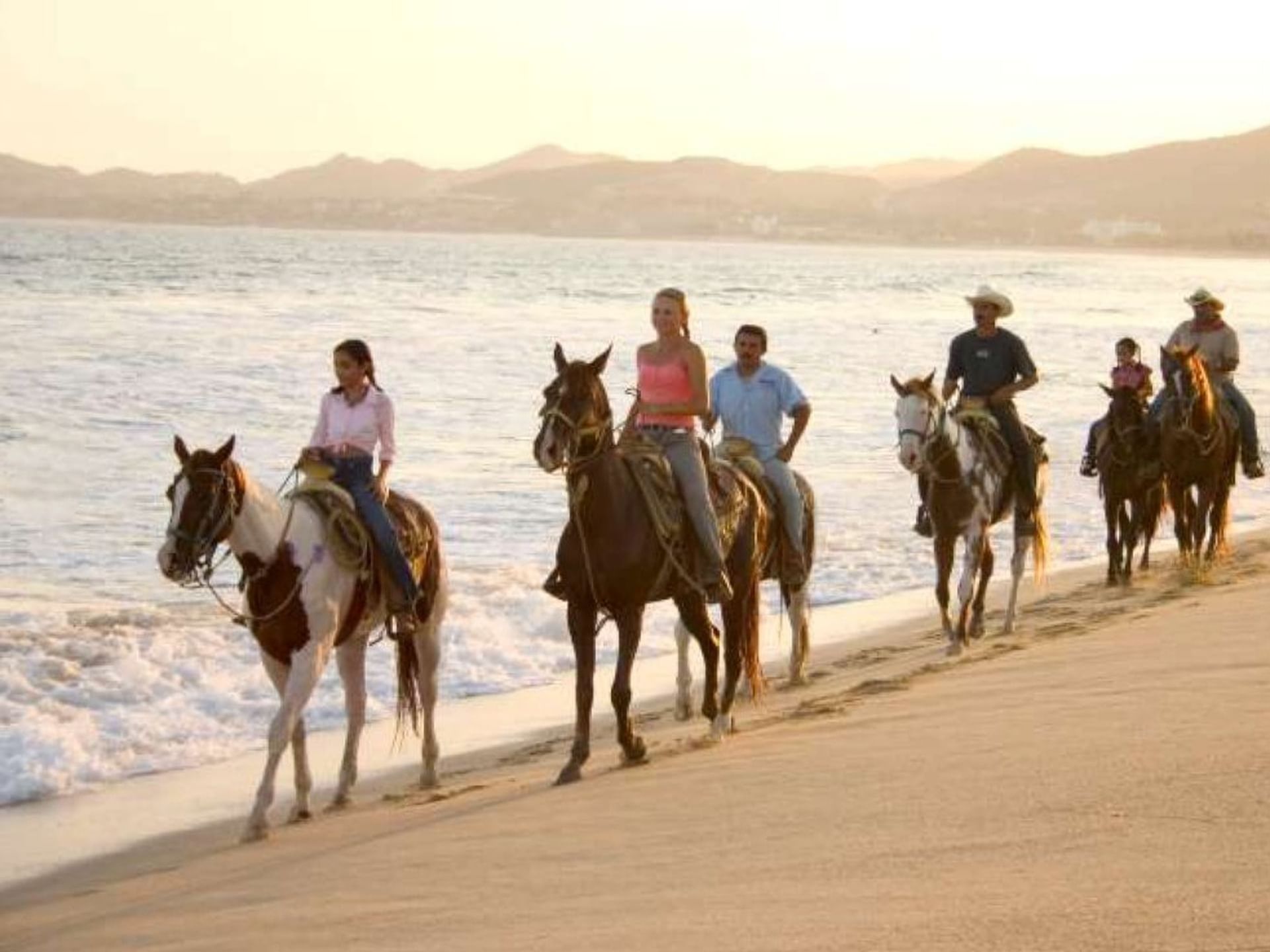 People horse-riding by the shore near Cala de Mar Resort