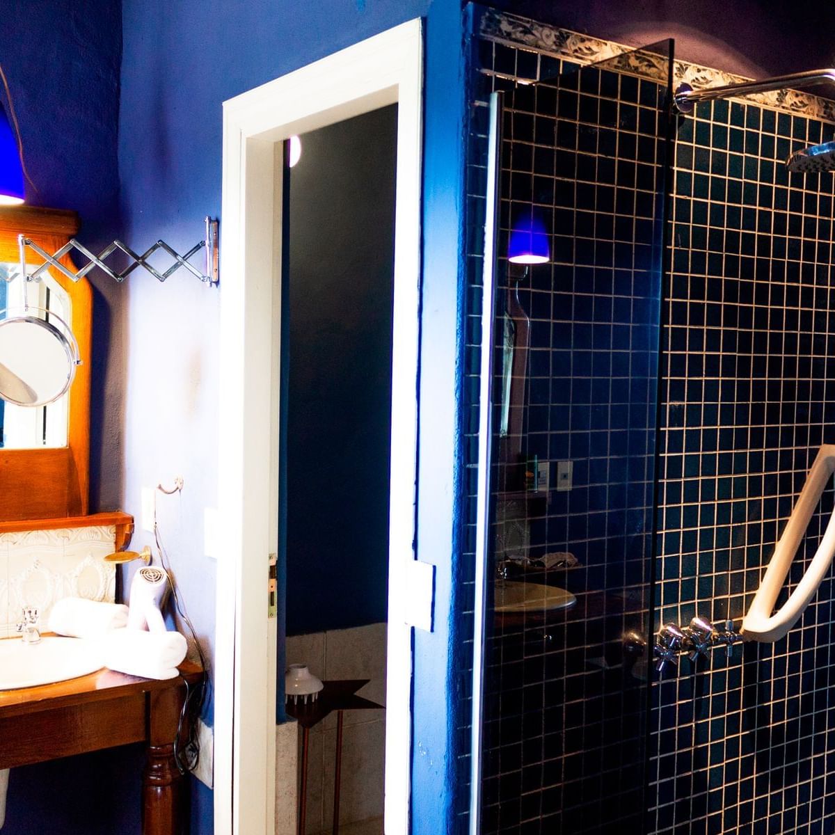 Bathroom shower & vanity area in Suite at DOT Hotels