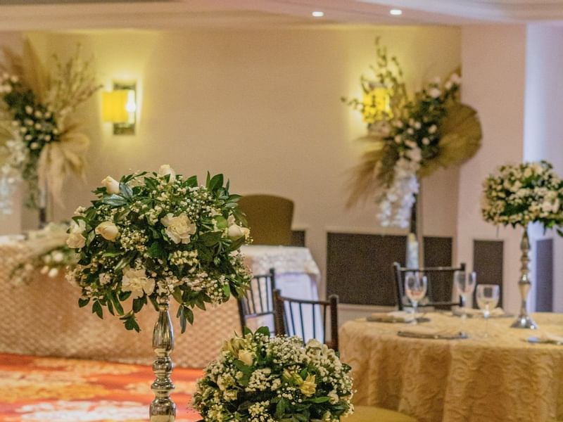 Floral centerpieces in Perlas B event room at Gamma Hotels