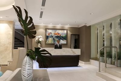 person standing behind reception area