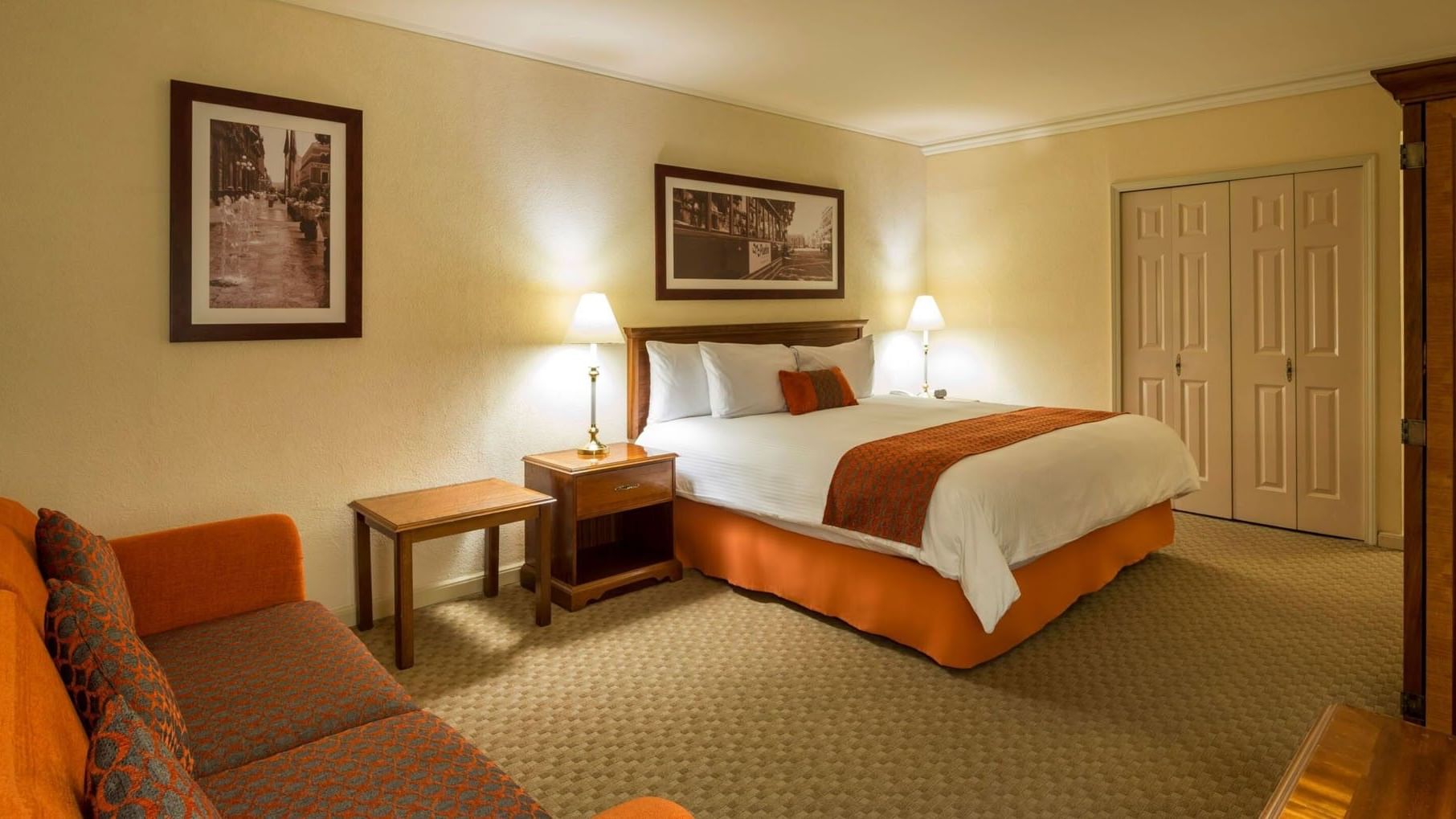 King Deluxe room with framed art, soft bedside lamps, and carpeted flooring at Camino Real Puebla Angelopolis