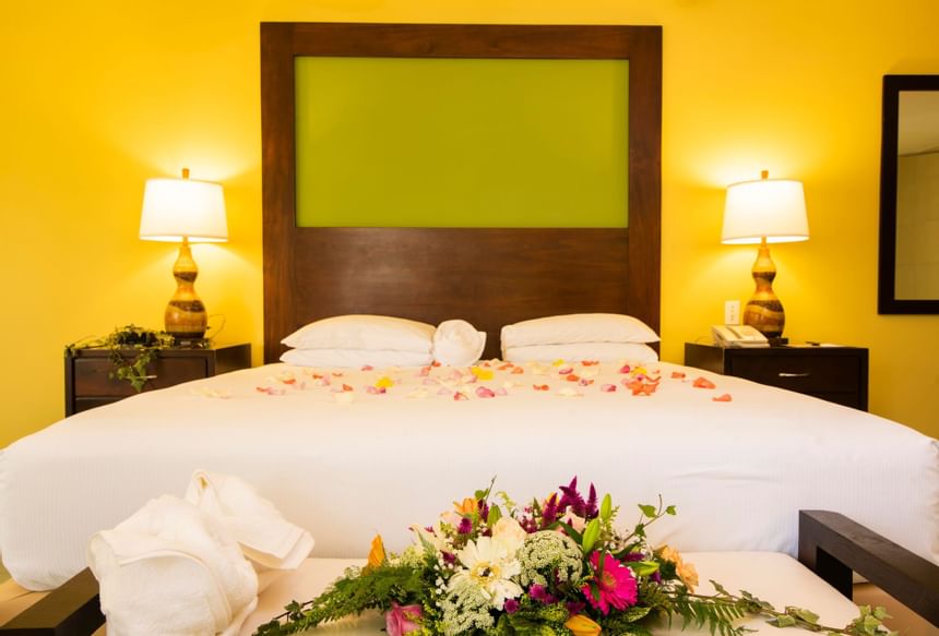 A bed decorated with flowers at Fiesta Resort 