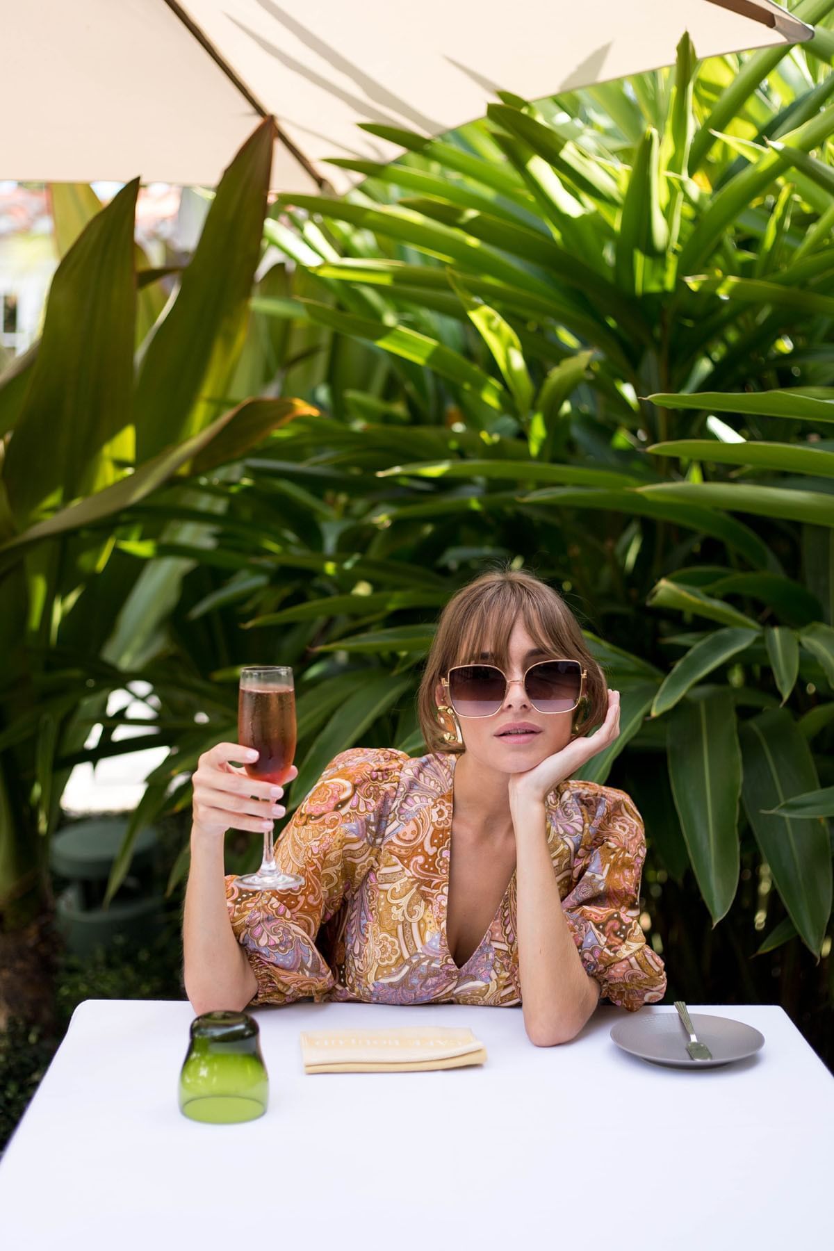 A woman drinking a cocktail at Brazilian Court 