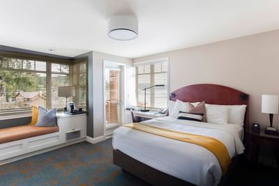Window lounge by a cozy bed in Waterfront Queen at Alderbrook Resort & Spa