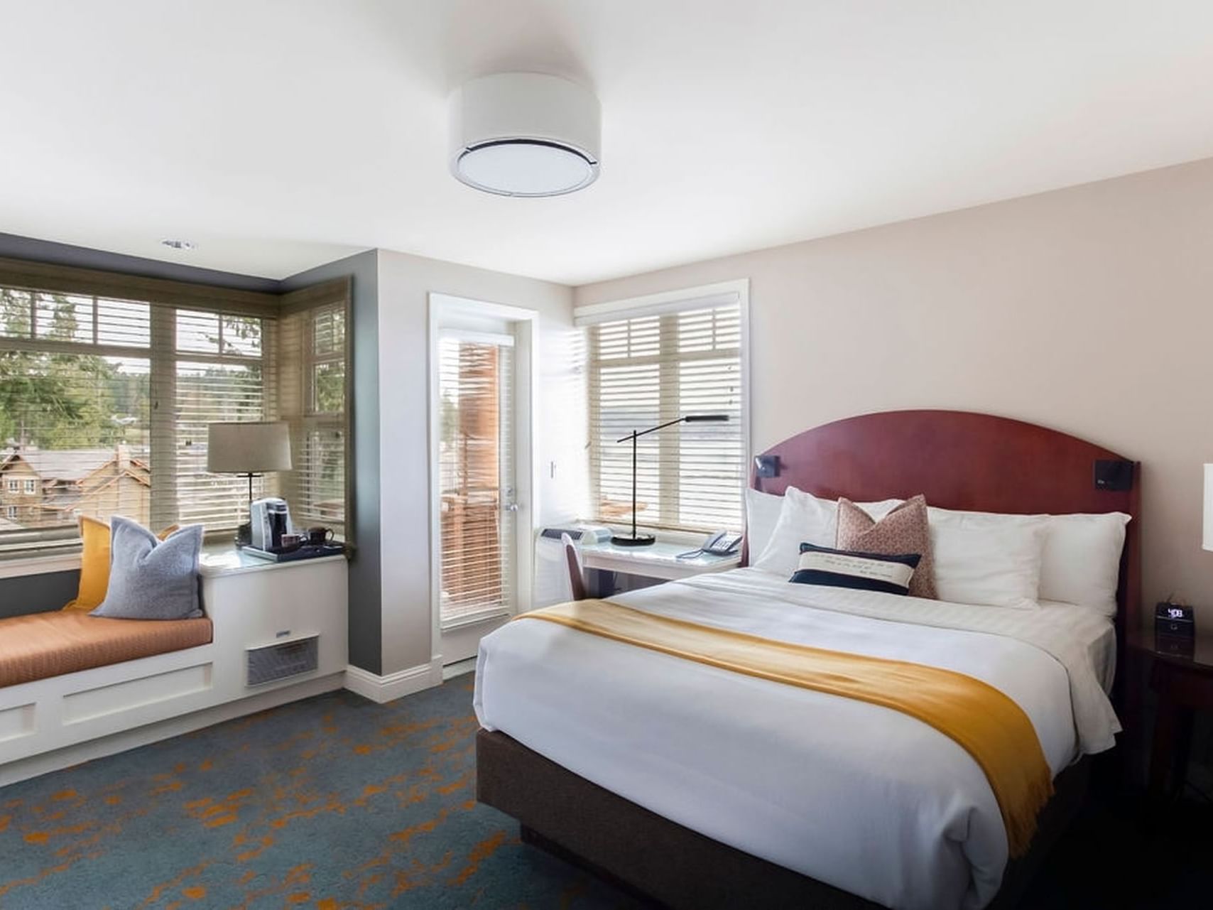 King-size bed with a window seat in Waterfront Queen at Alderbrook Resort & Spa