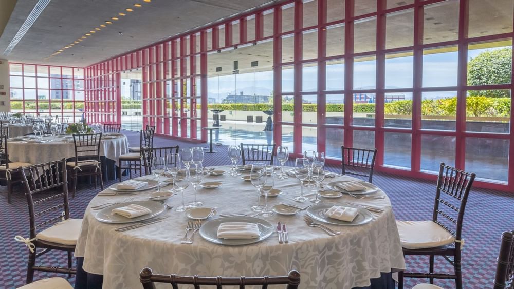 Terraza banquet room featuring pink window frames and white-clothed tables at Camino Real Polanco Mexico