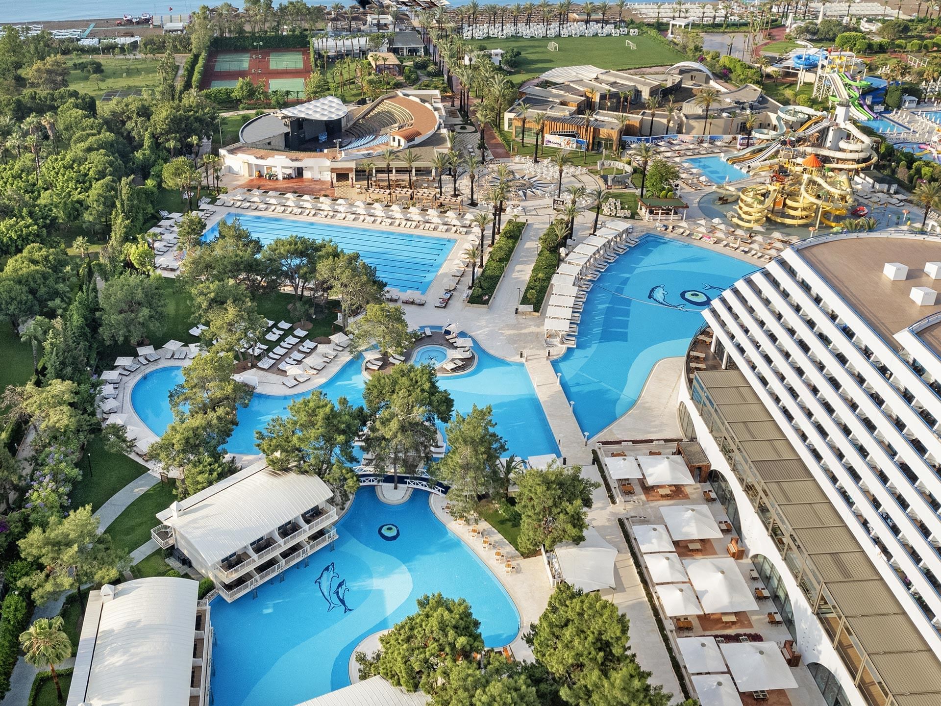Aerial view of the hotel and the pool with garden near the ocean at Titanic Deluxe Lara