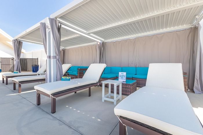 A spacious cabana with comfortable seating at Off Shore Resort