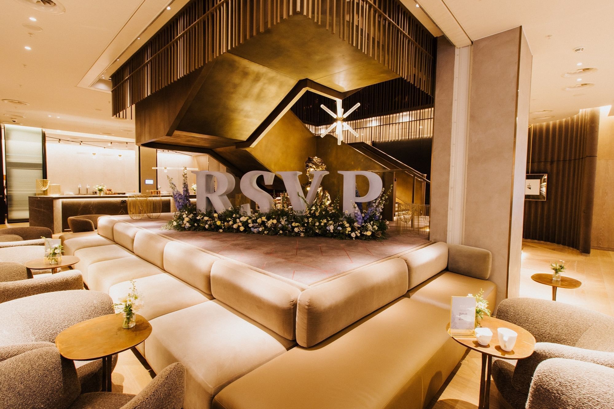 Luxurious lobby area arranged with the cozy seating at The Londoner Hotel