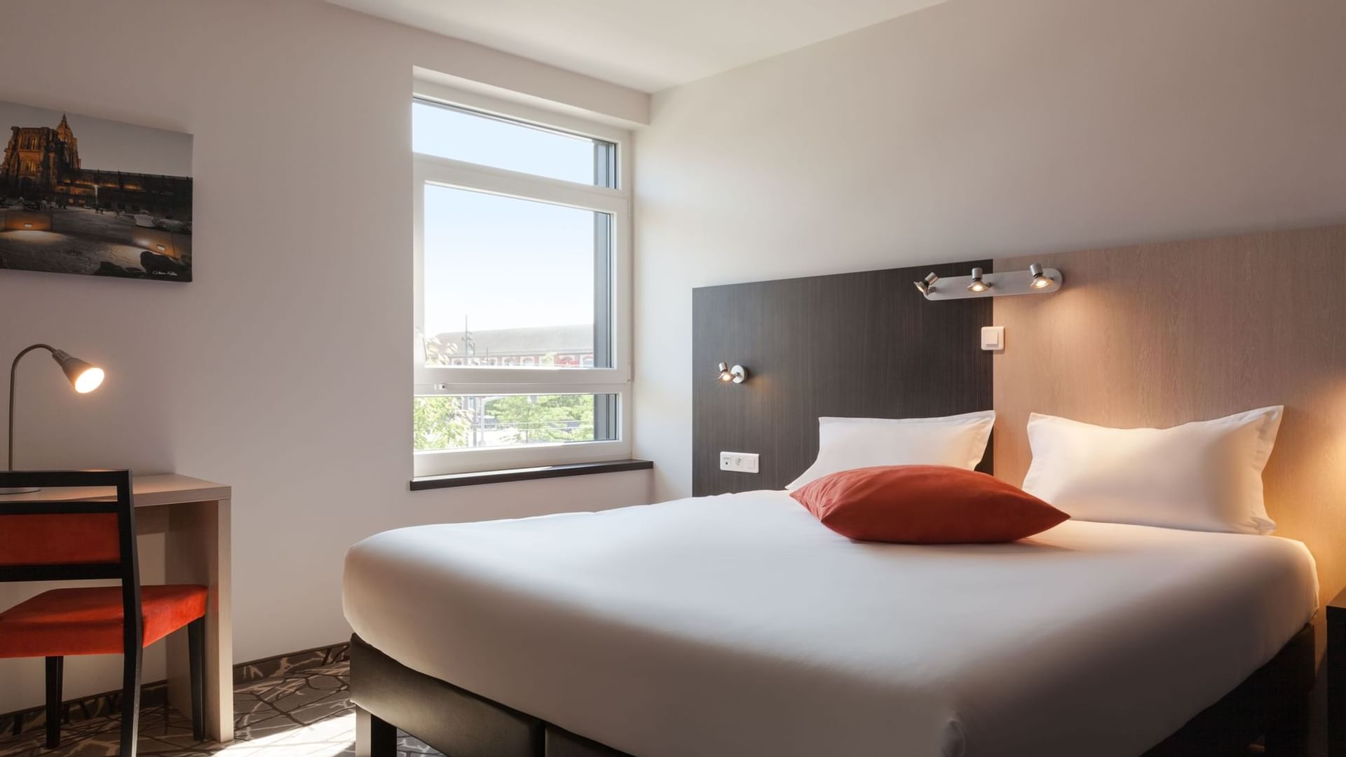Modern bedroom with a bed & work area at The Originals Hotels