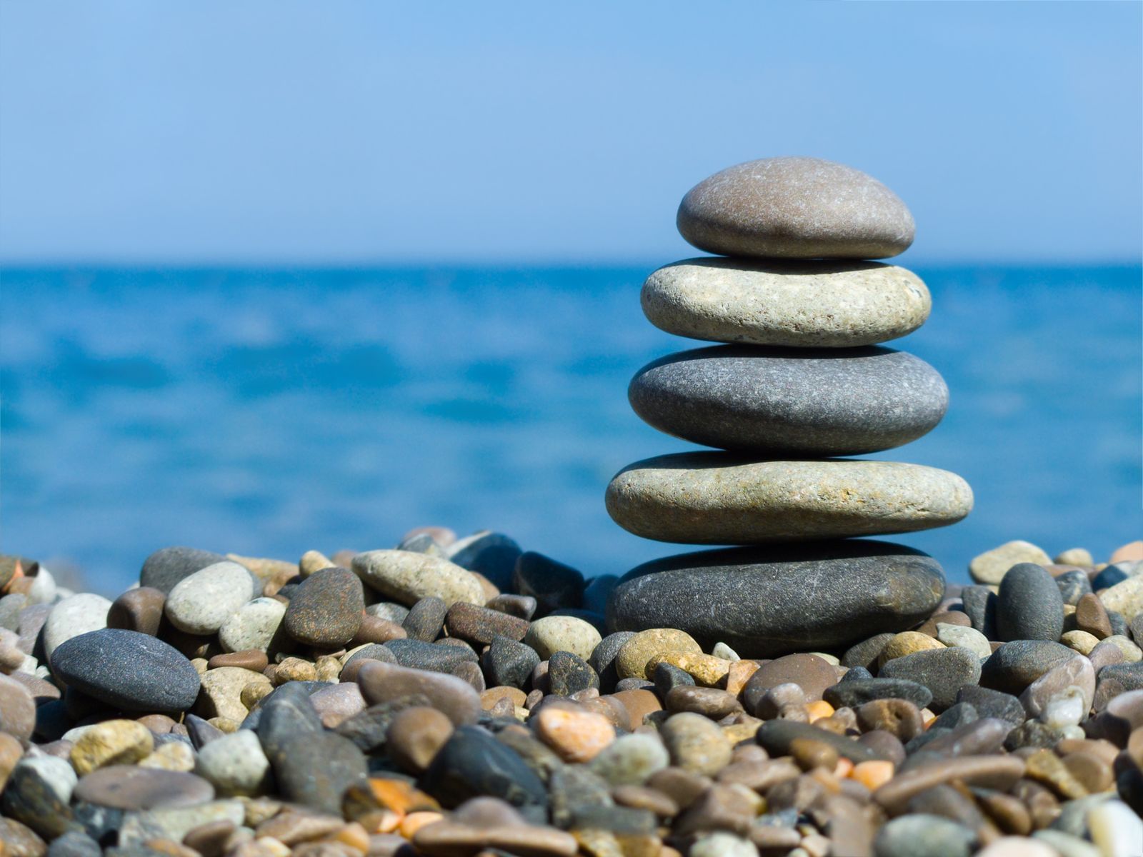 An image of stones stacked by the beach