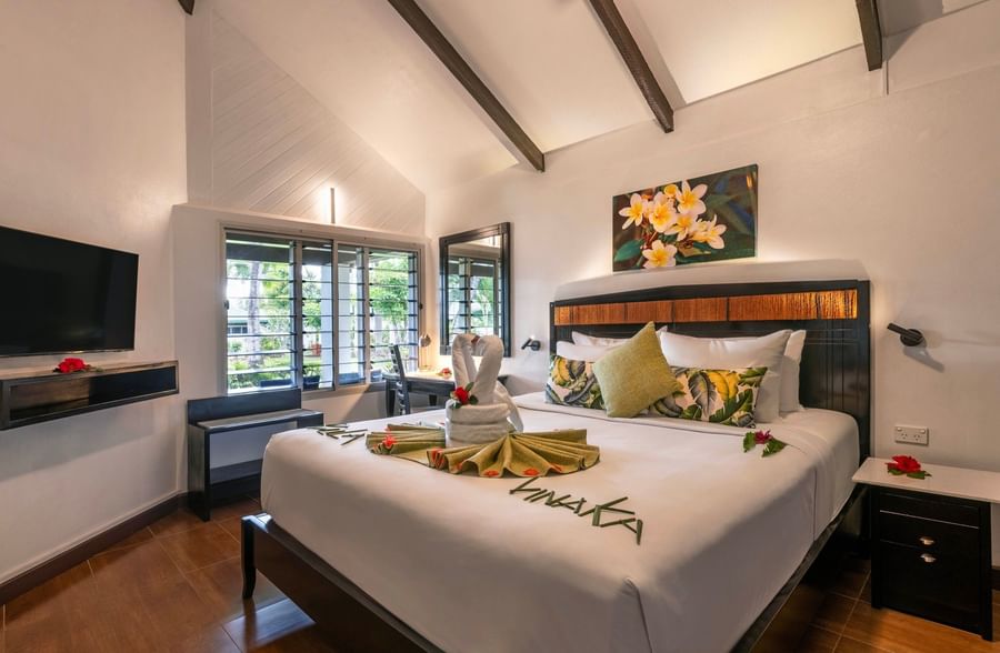 Elegantly decorated hotel room with a large bed at Tokatoka Resort Fiji International Airport.