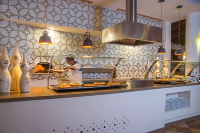 Chef making pizza in an oven at Buenaventura Grand Hotel