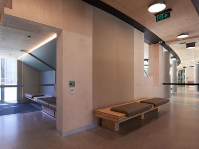 Modern interior of La Trobe University North and South Apartments with a wooden bench and a compact sleeping area.