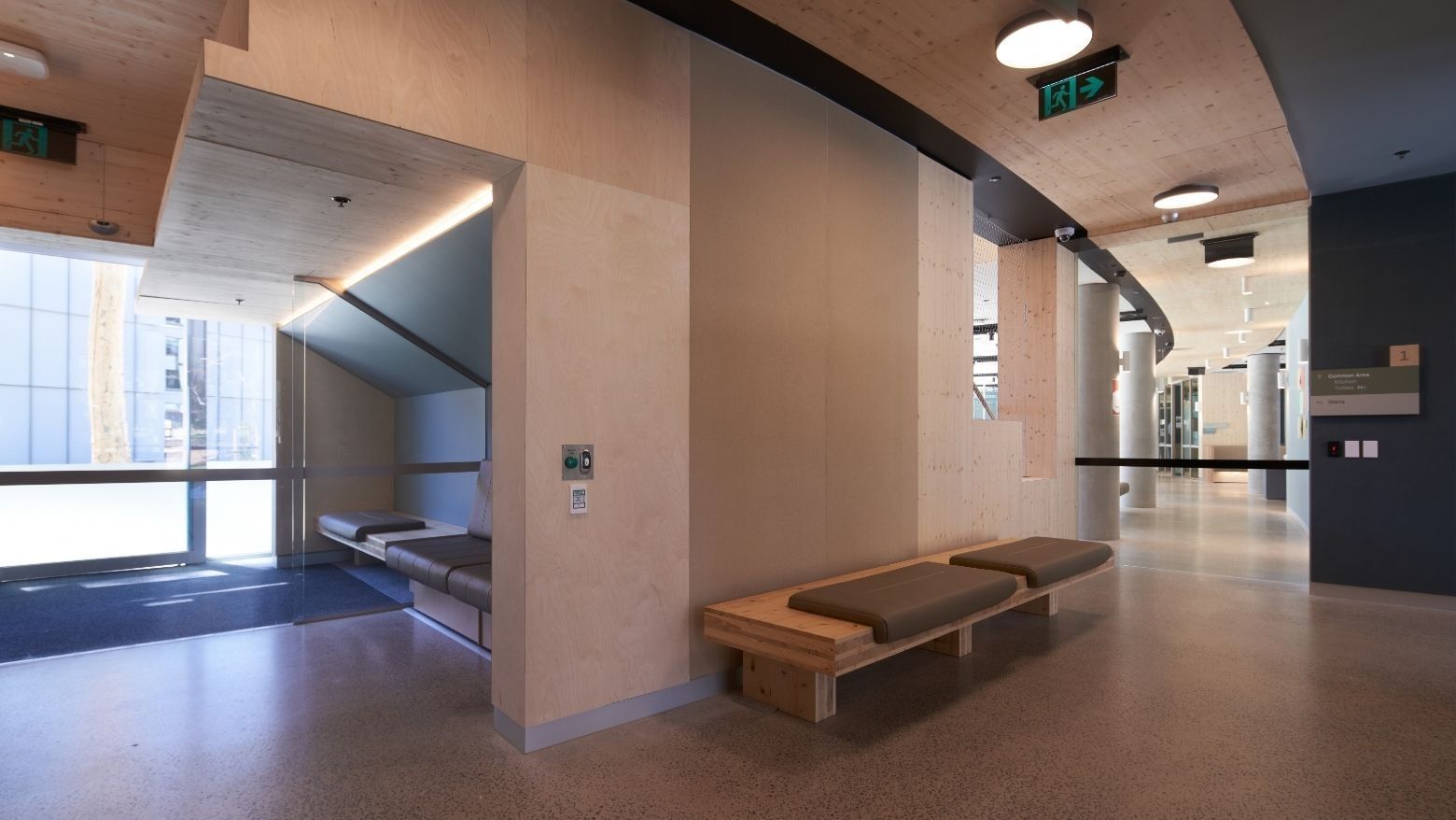 Modern interior of La Trobe University North and South Apartments with a wooden bench and a compact sleeping area.