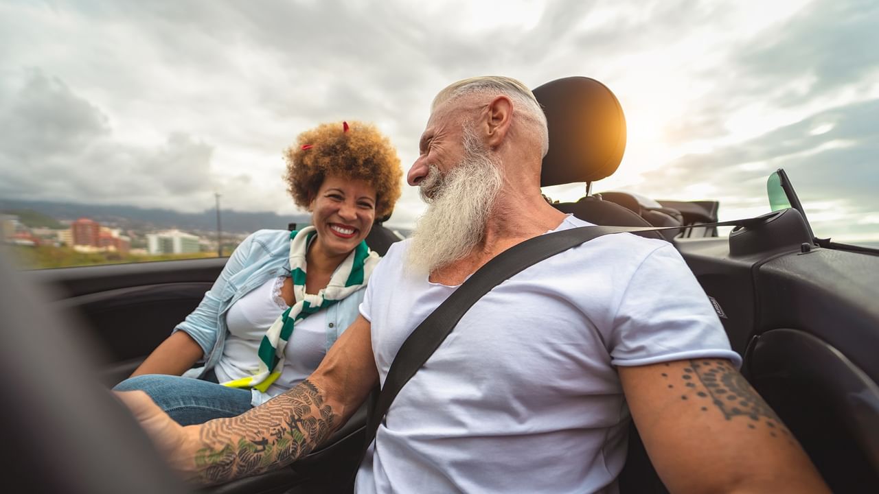 couple enjoying a drive together in a convertible