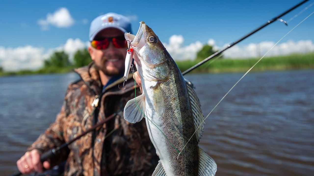 Man holding a fish on a hock