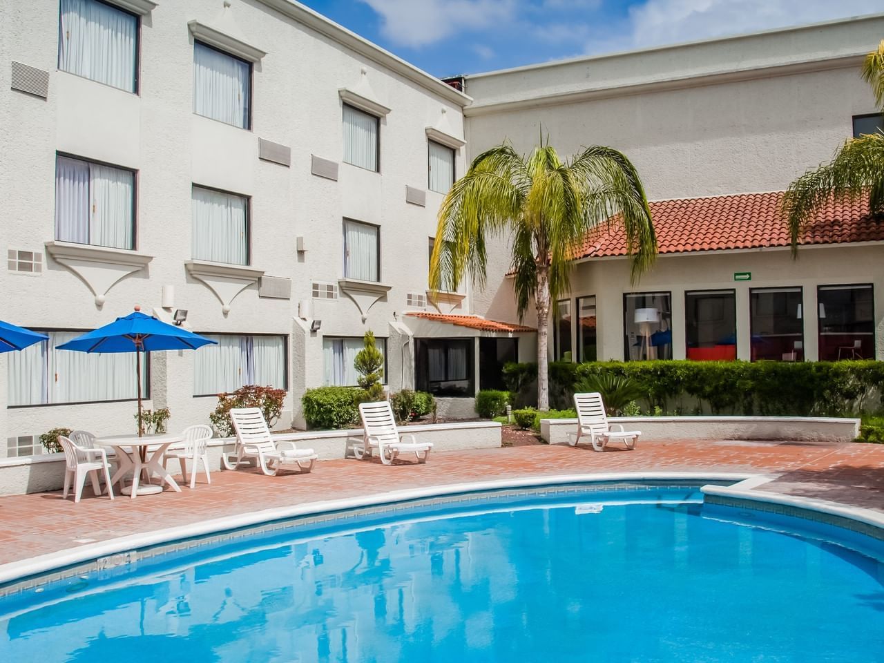 Outdoor swimming pool area with pool beds at Fiesta Inn Hotels