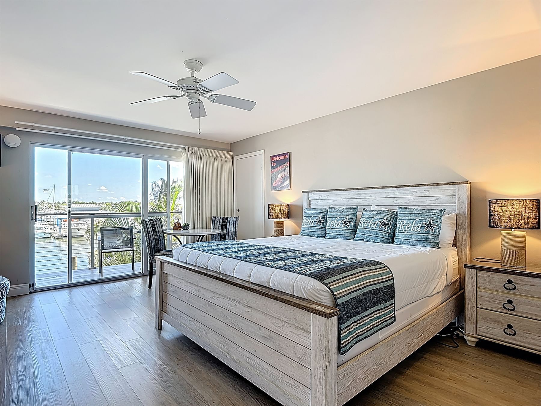 Cozy bedroom with a large bed and balcony view at Cove Inn at Naples Bay, Naples.