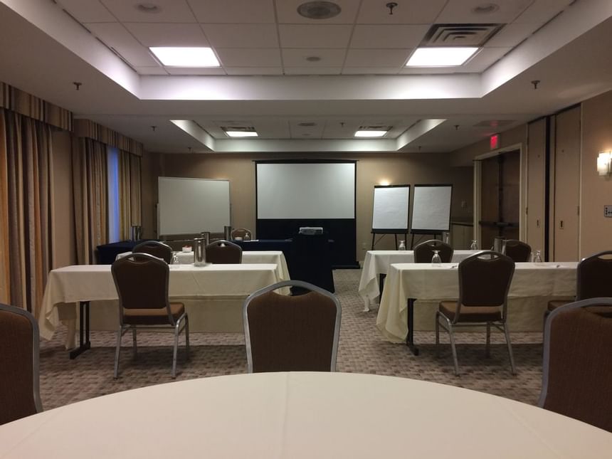 Tables arranged for a meeting in the hall at UMass Lowell Inn