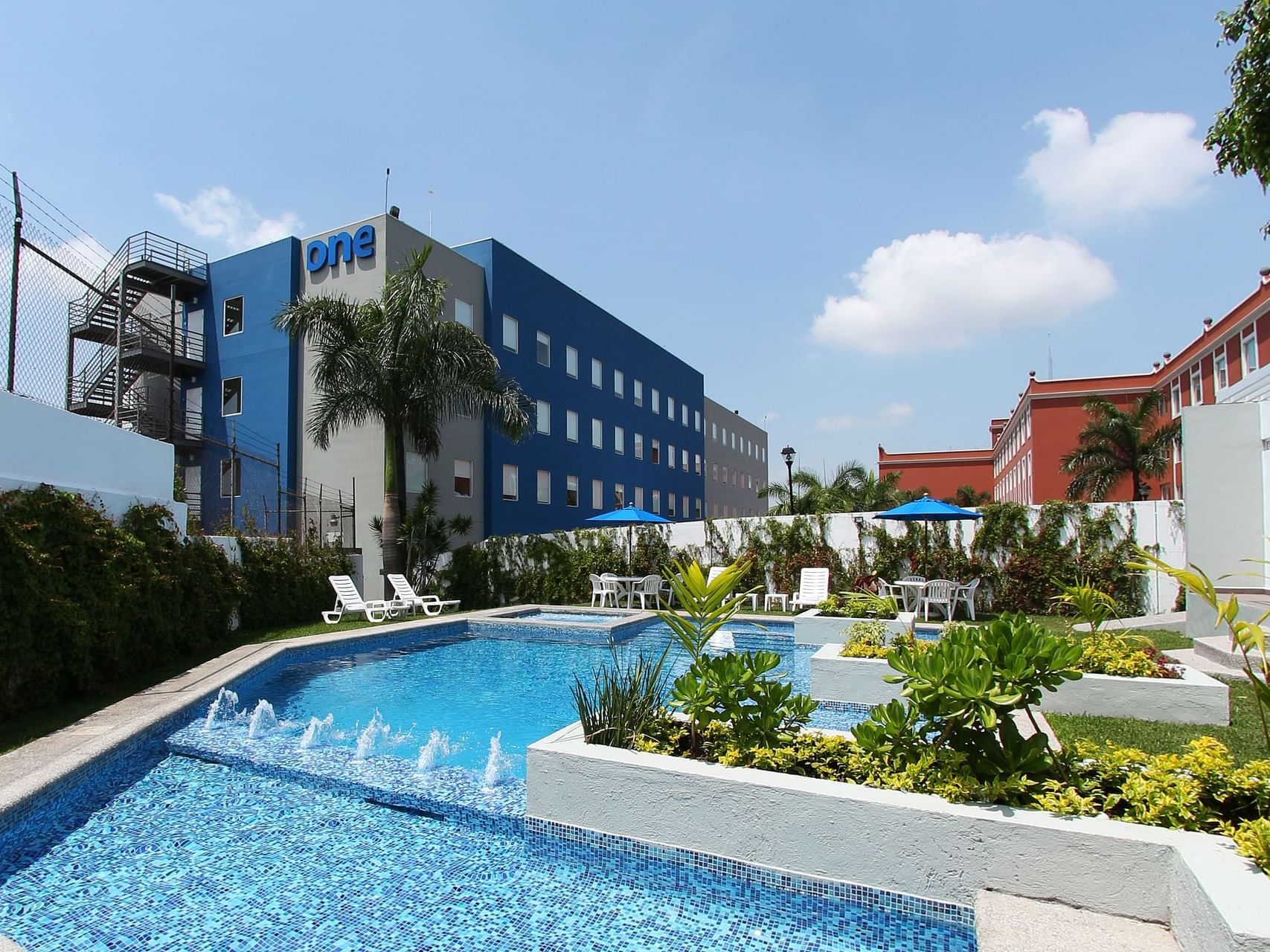 Sunbeds by the outdoor pool area at One Hotels