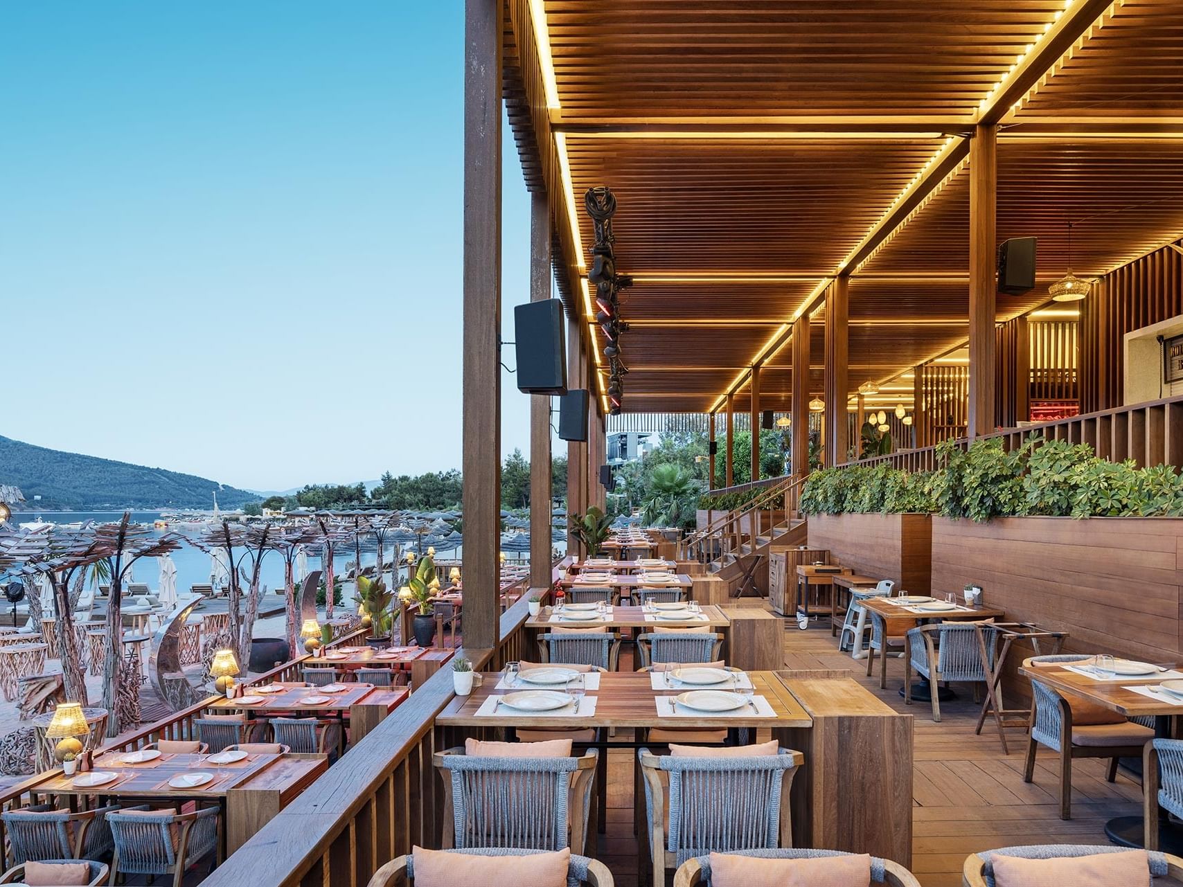Stylish open-air restaurant terrace with sea view at Titanic Luxury Collection Bodrum.