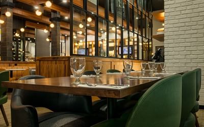 Well-arranged dining area with green seating at Fort McMurray Hotel