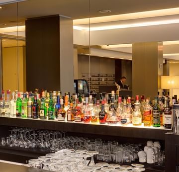 Bar counter with various beverages self in the Lobby Bar at Sylter Hof Berlin