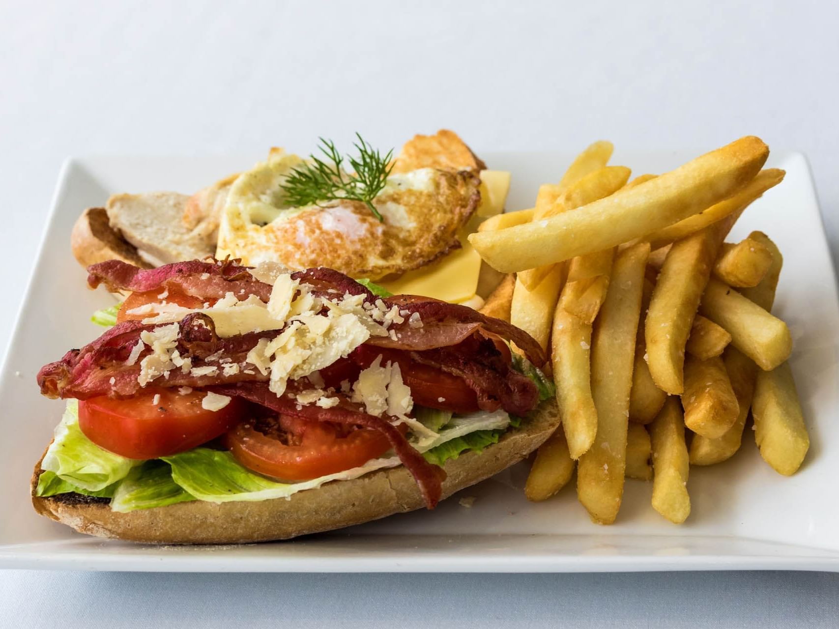 Close-up of a Club Sandwich with a side of fries at Grand Chancellor Townsville