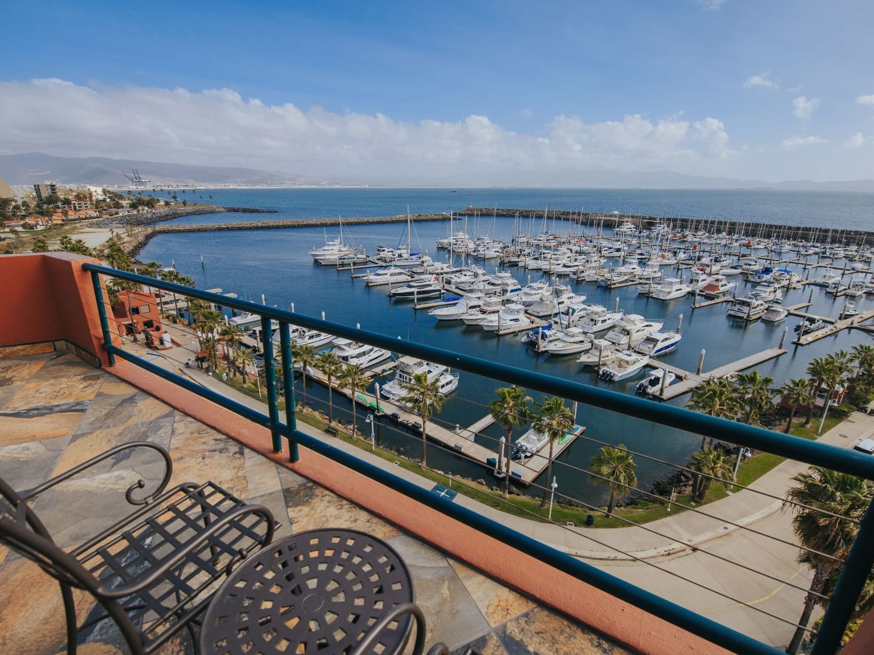 View of the beautiful marina full of boats from a room balcony on a sunny day at the luxurious Hotel Coral y Marina