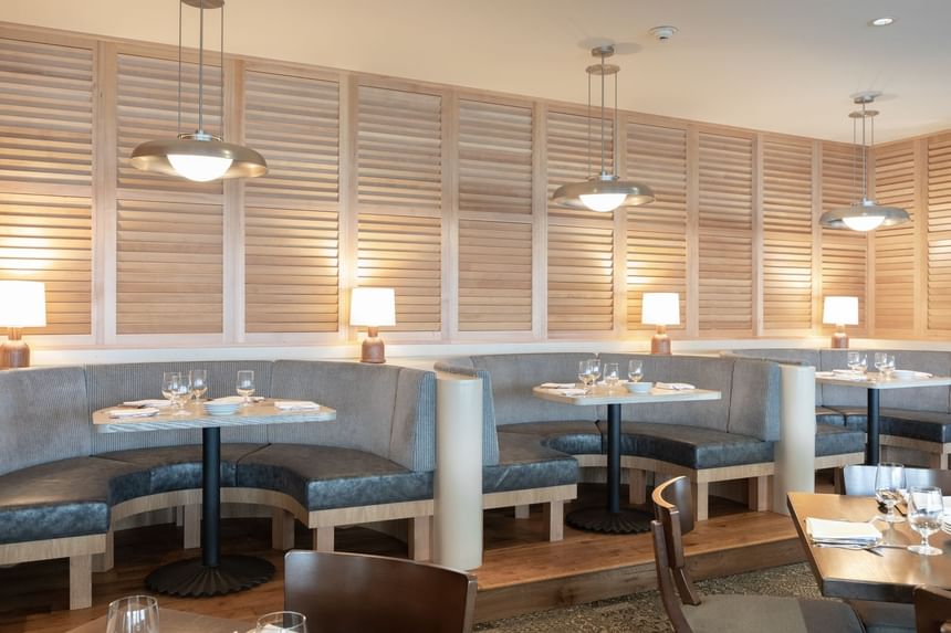 Dining area with booths in The Restaurant at Alderbrook Resort & Spa
