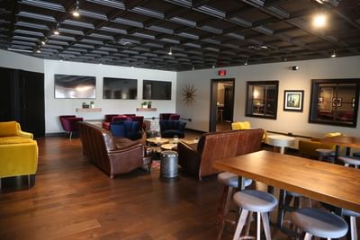 three wall mounted tvs in a living area
