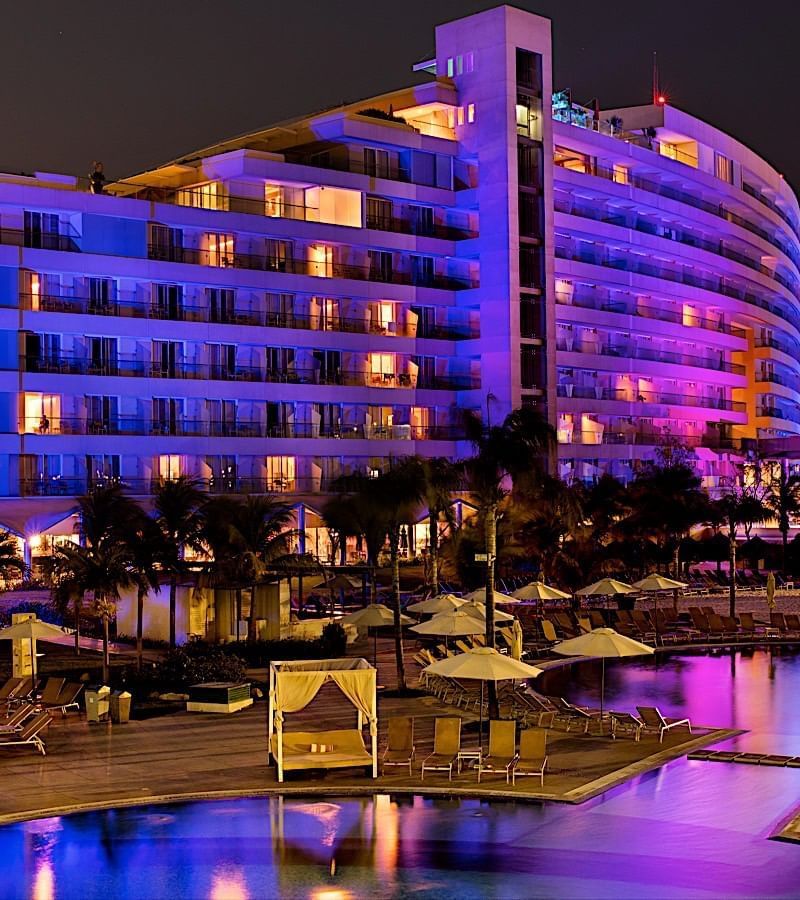 Exterior view of Mundo Imperial and the pool at night