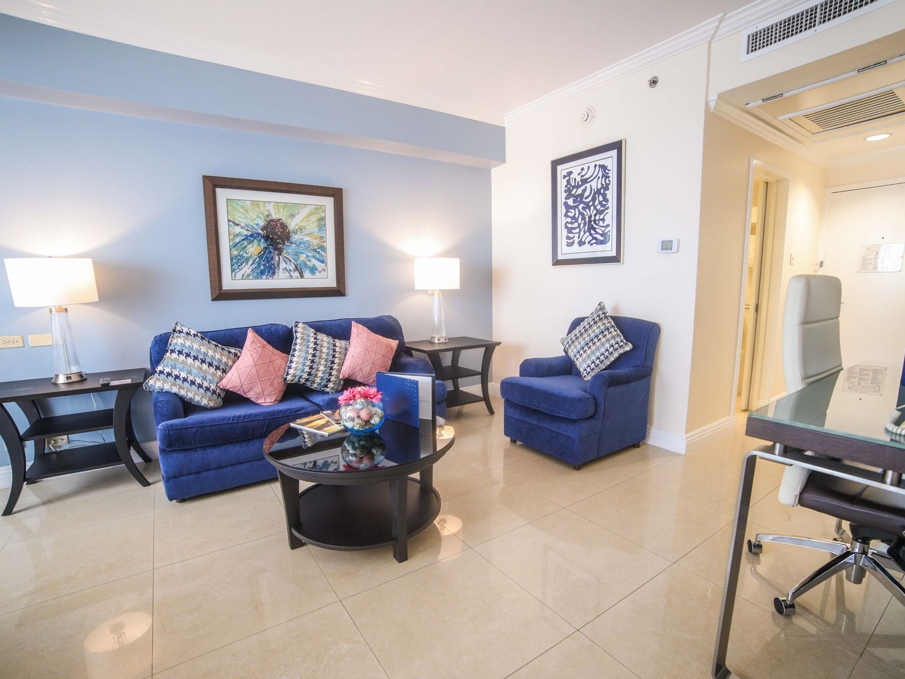 Living area with sofa and workspace in Royal One Bedroom Suite at Jamaica Pegasus Hotel