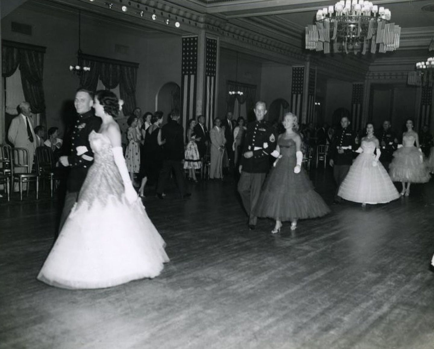 Vintage image of couples dancing by flags under a crystal chandelier in a grand ballroom at Arlington Resort Hotel & Spa