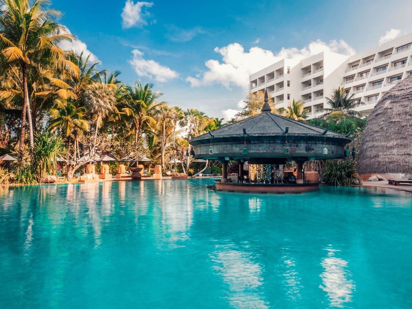 Sunbeds & a dining area by the Pool at Paradox Hotels & Resorts