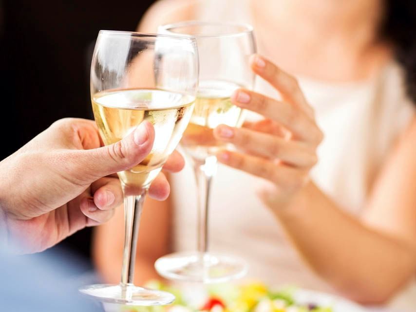 Close-up of a couple toasting at Hotel Grand Chancellor Adelaide