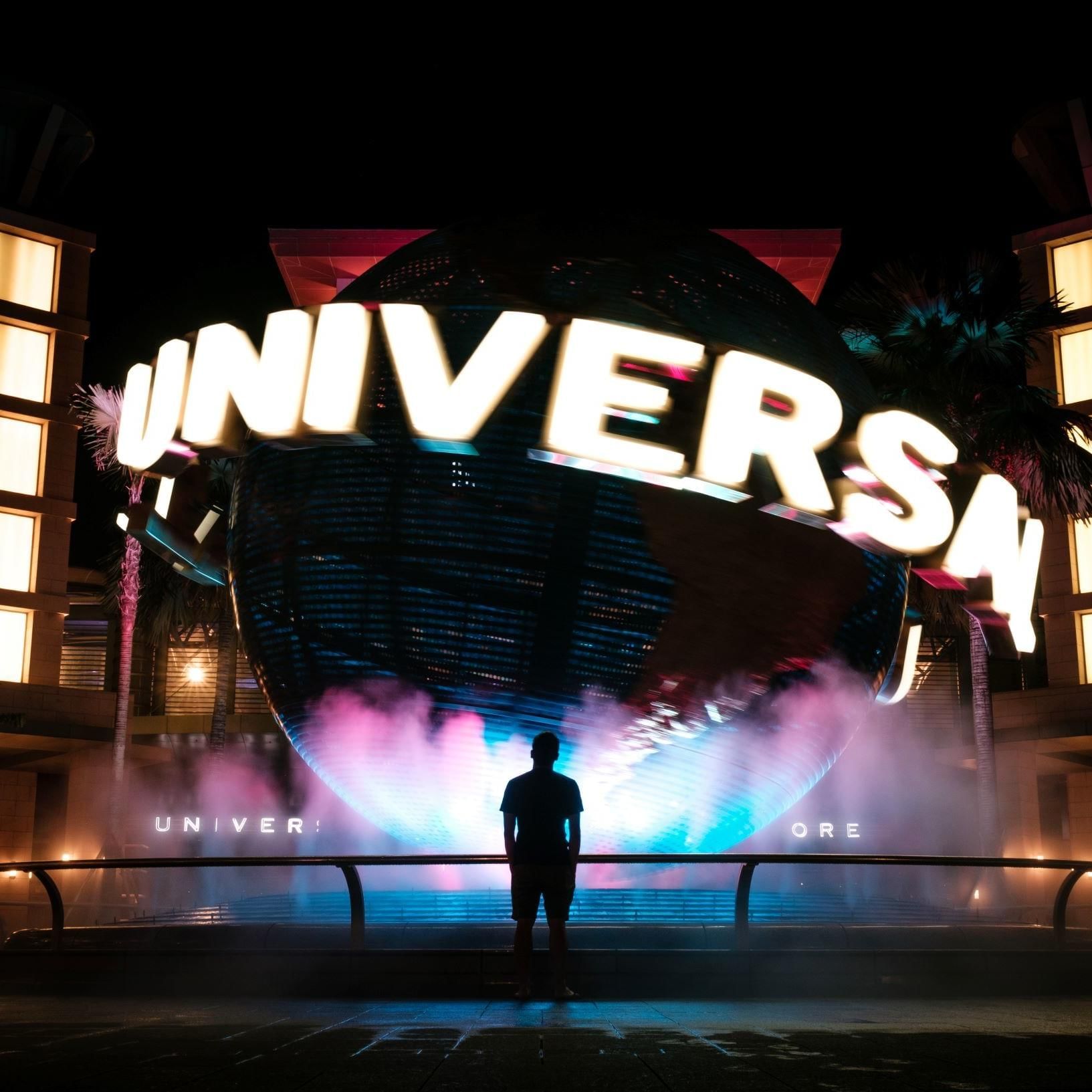 Man standing in front of The Universal Studios near DOT Hotels
