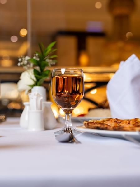 Close-up of a set dining table with glasses of juice and tea in Al Duhaa restaurant at Saja Warwick Madinah