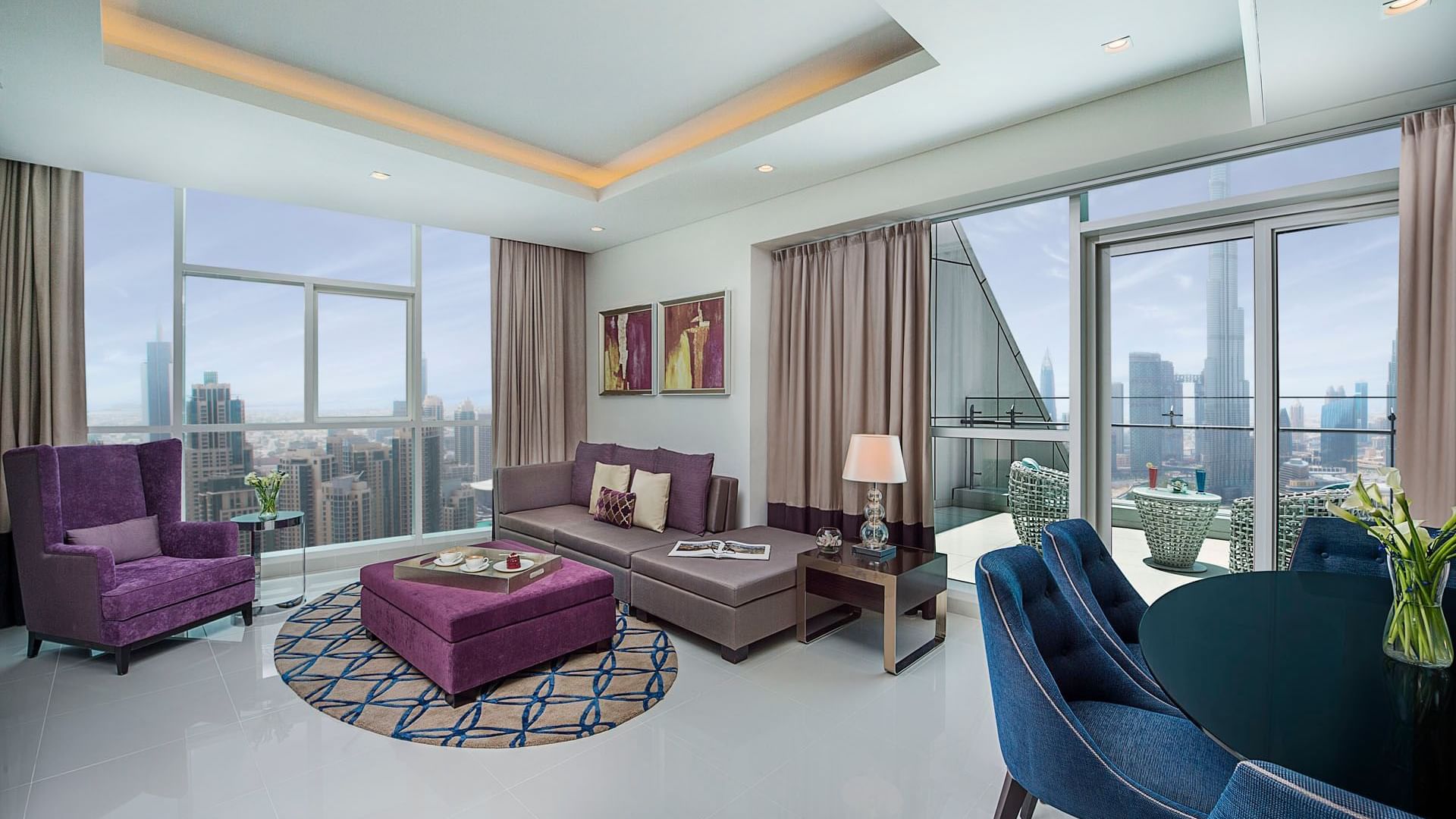 Spacious living area with cozy couches by the balcony view in Three Bedroom Suite at DAMAC Maison Distinction