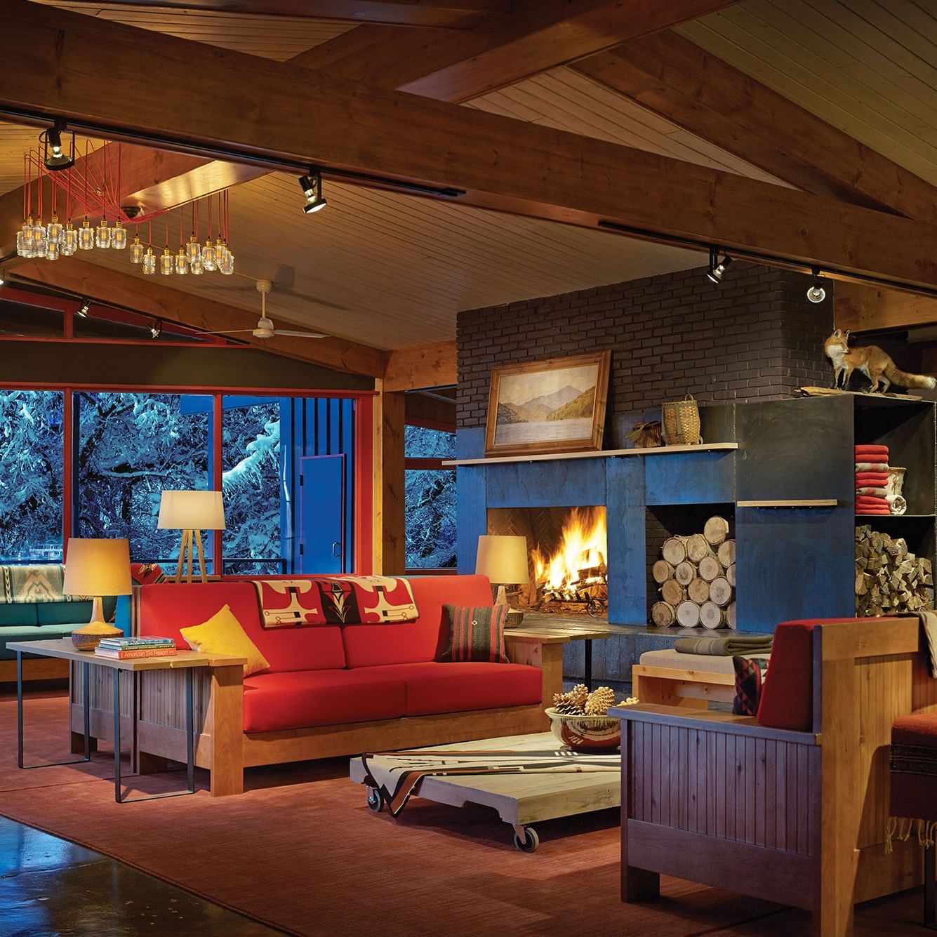 Warm cozy living room with fireplace and large windows ready for Lake House Olympic Watch Party.