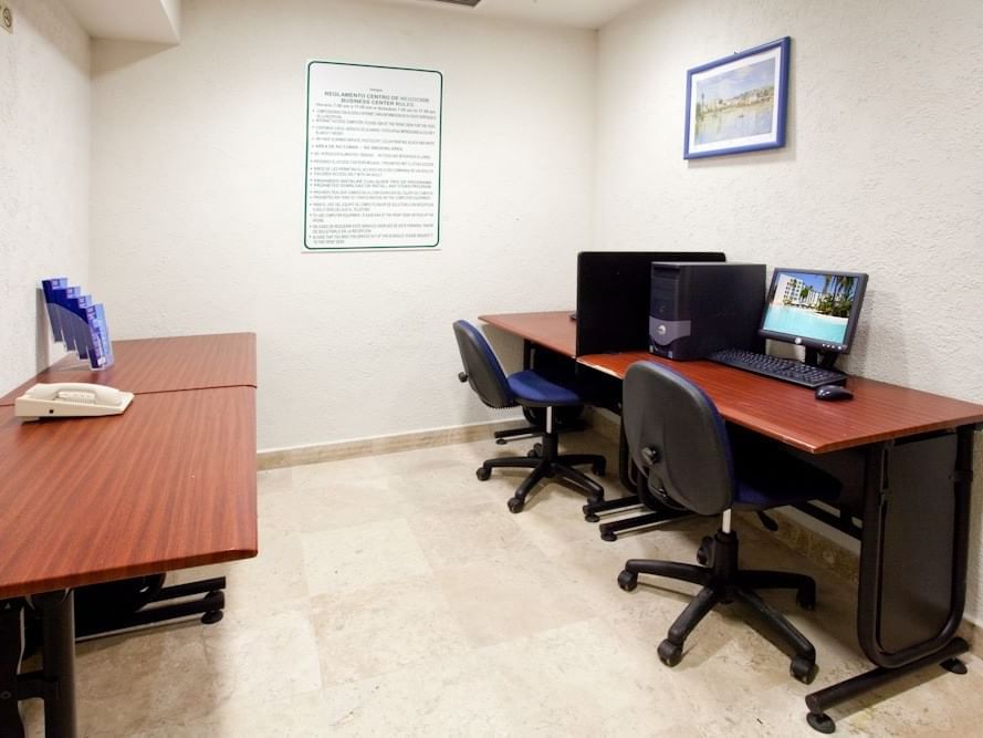 Computers & desks in the business center at Gamma Hotels