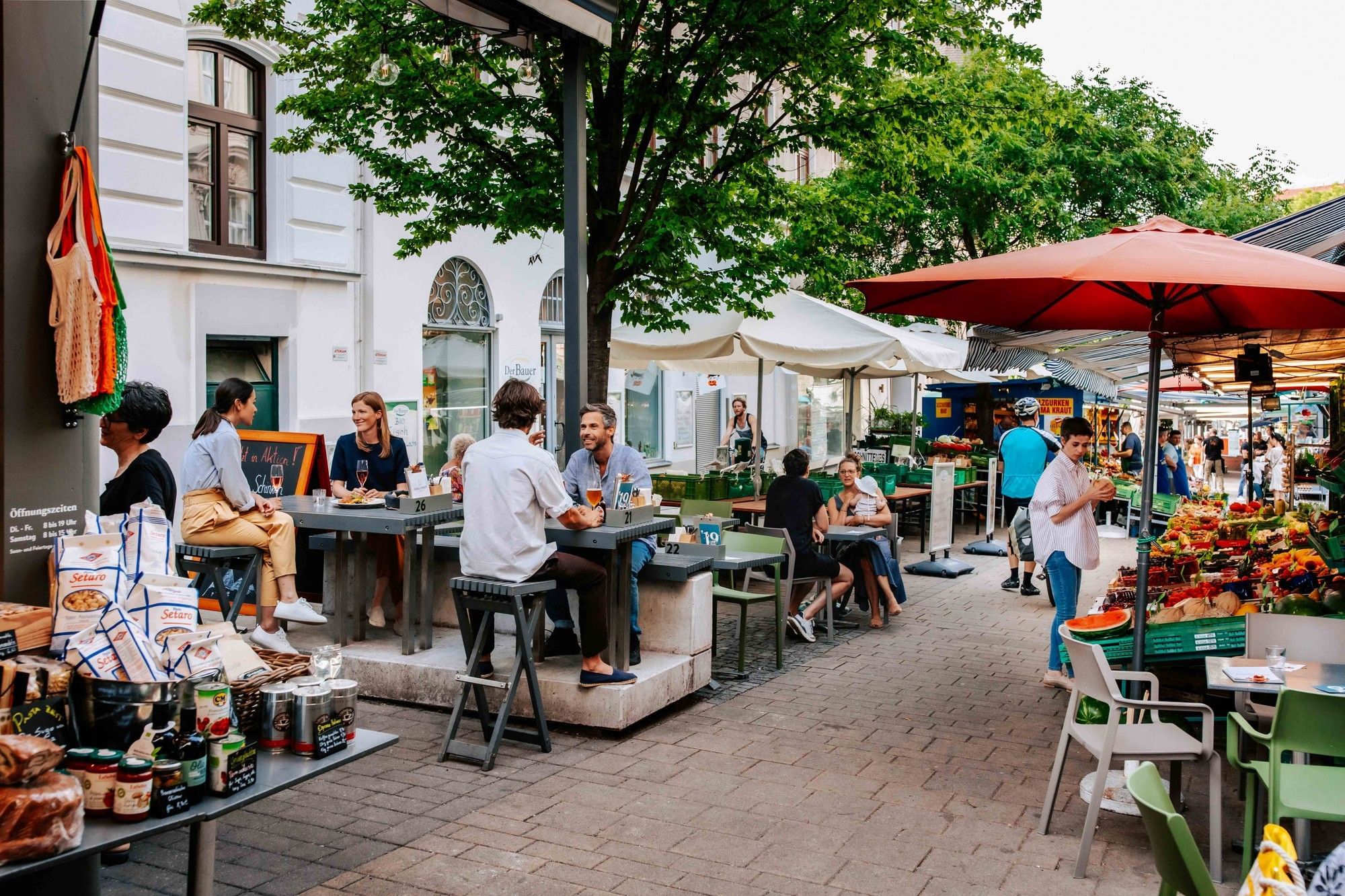 Kutschkermarkt in Vienna with a cozy outdoor dining atmosphere, market stalls and fresh produce