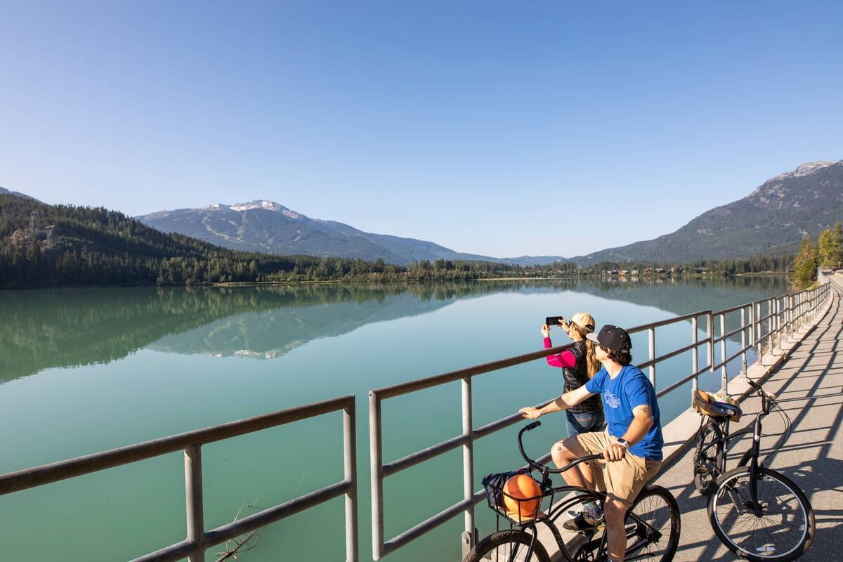 People exploring Green Lake from the bridge near Blackcomb Springs Suites