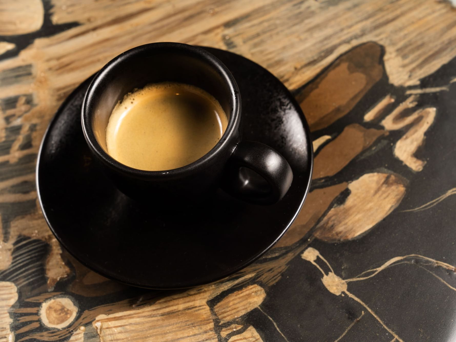 Close-up of a cup of coffee served with a saucer in Coffee Bar at The Earl