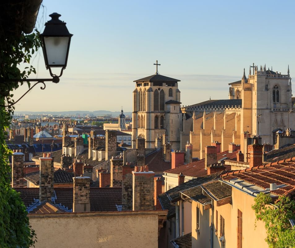 Rooftop view of historic chimneys and Saint-Jean-Baptiste Cathedral at Warwick Reine Astrid - Lyon