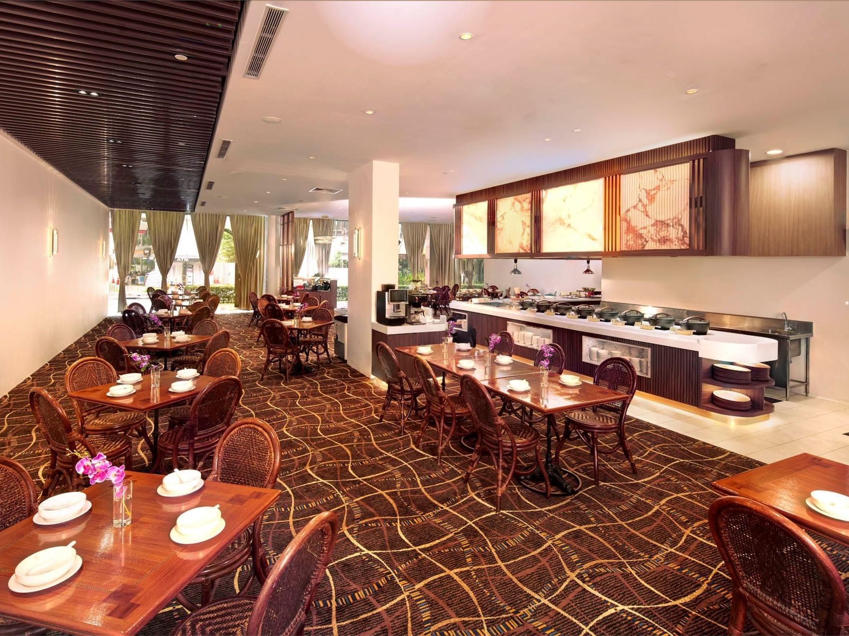 Bright, modern Crystal Café with wooden tables, buffet area, elegant décor, and natural light at Orchard Grand Court